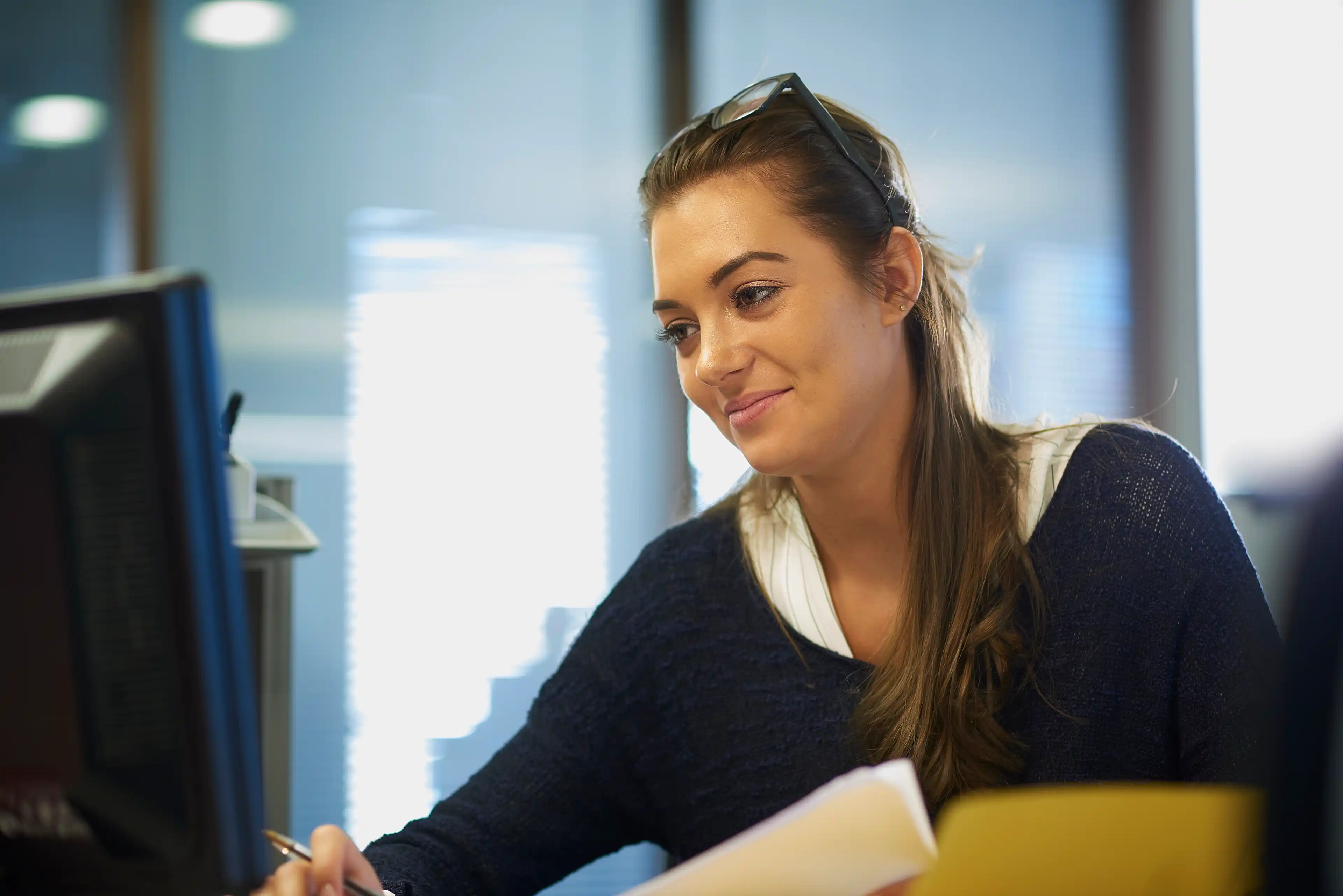 Business woman checking details on a computer