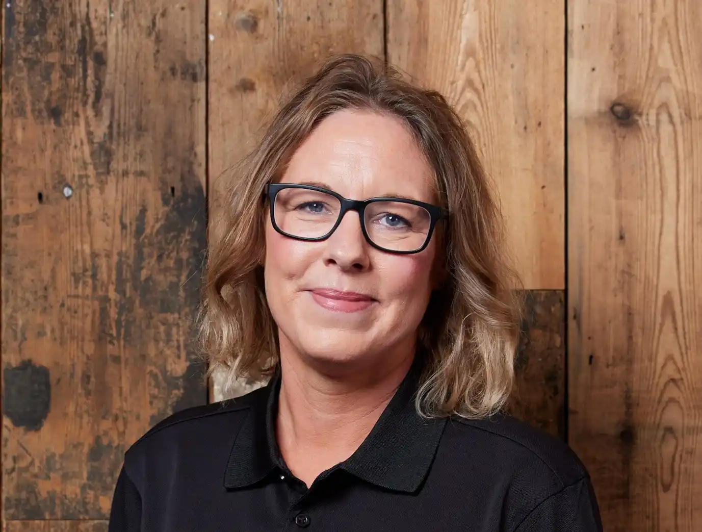image of Emma Bohan, a woman wearing a black top and black glasses