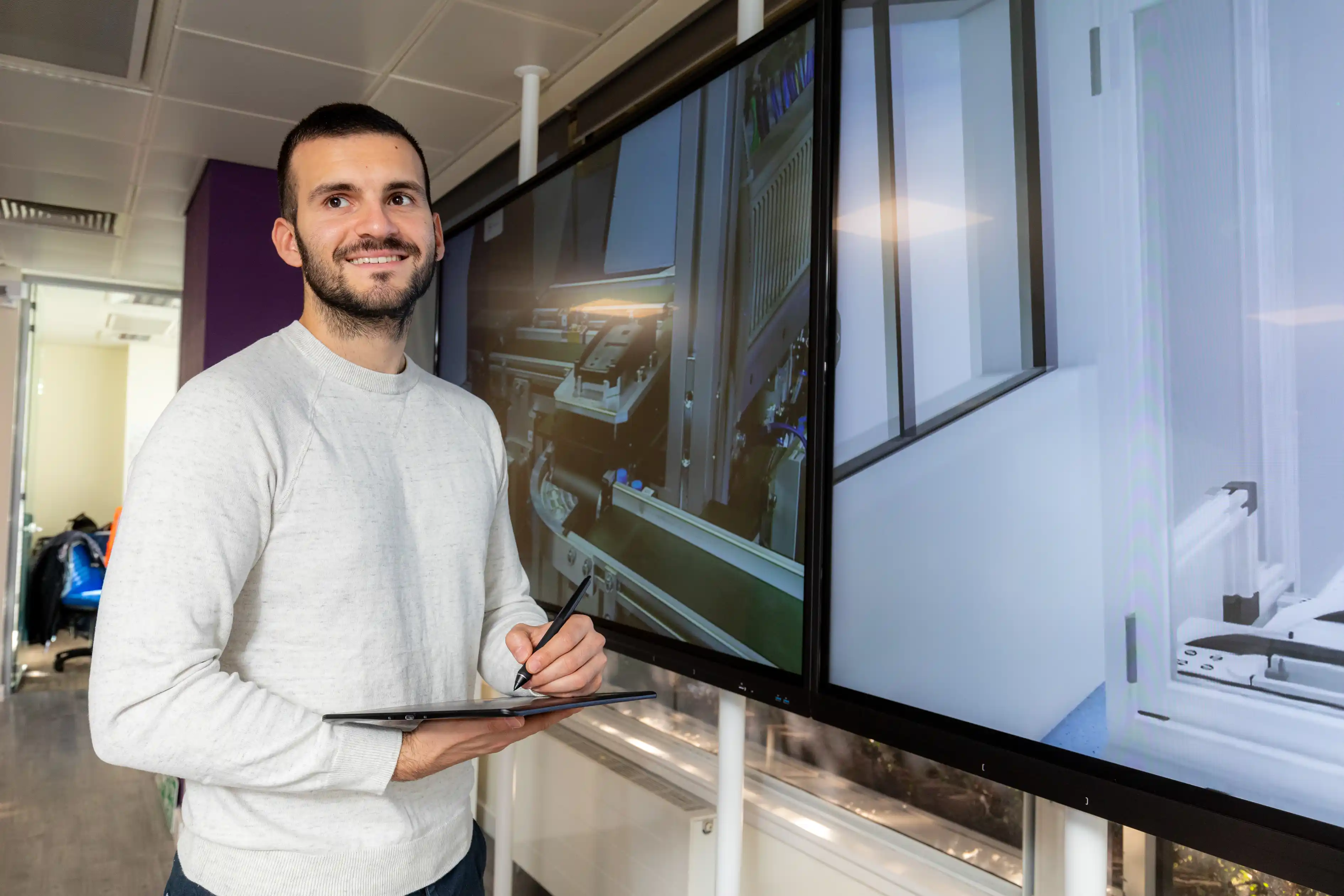 University College Birmingham student showing their engineering project on screens.