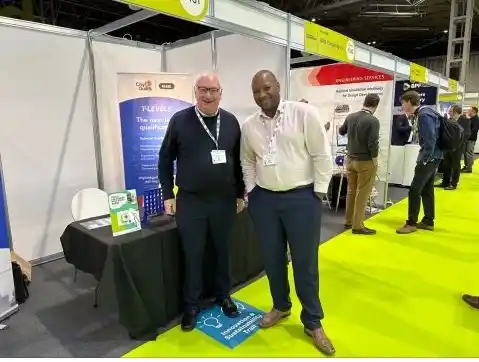 Two people posing at the camera at an event