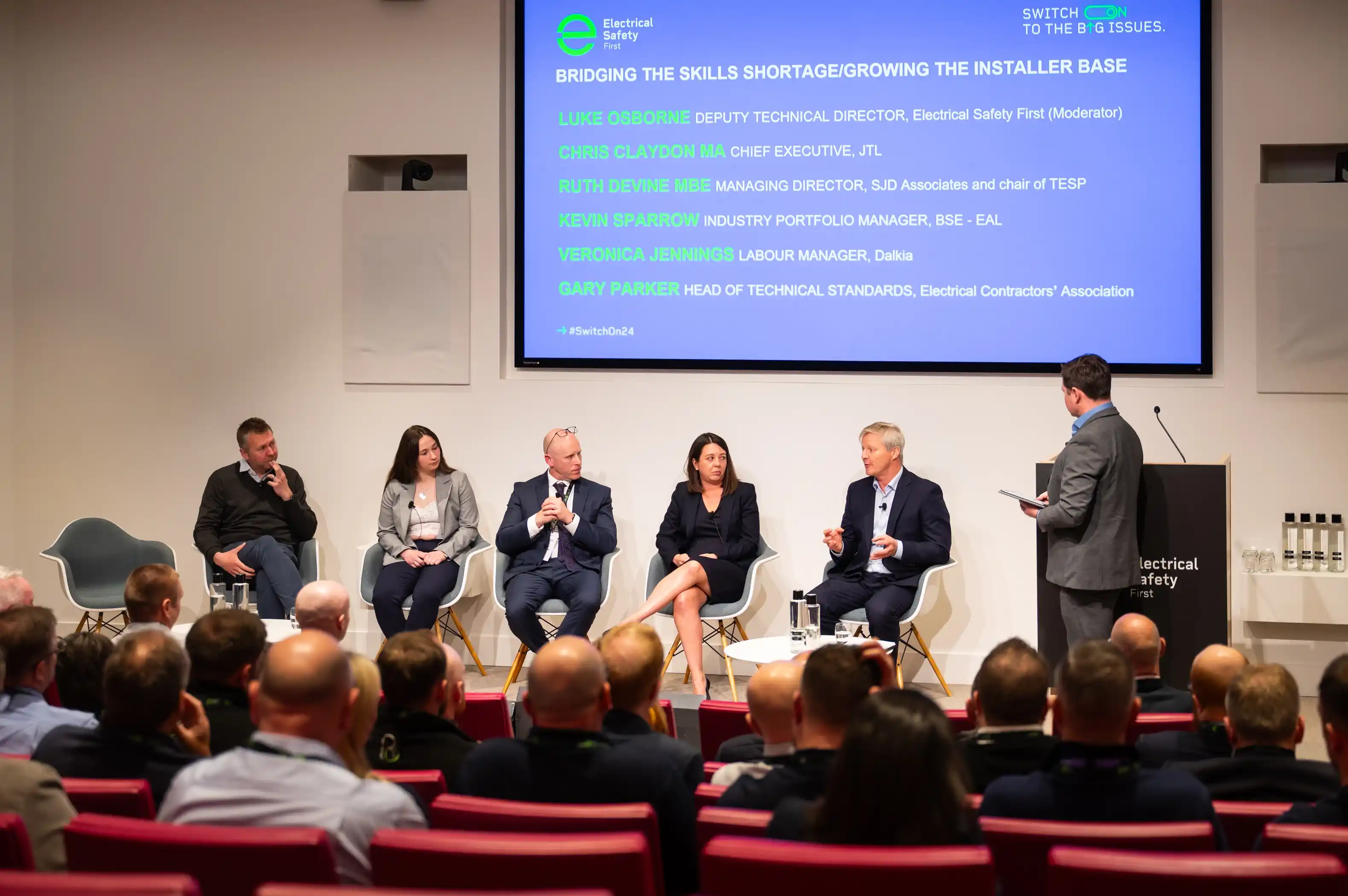 EAL's Kevin Sparrow sat on stage in a panel next to 4 other panellists and host at Electrical Installation Seminar.