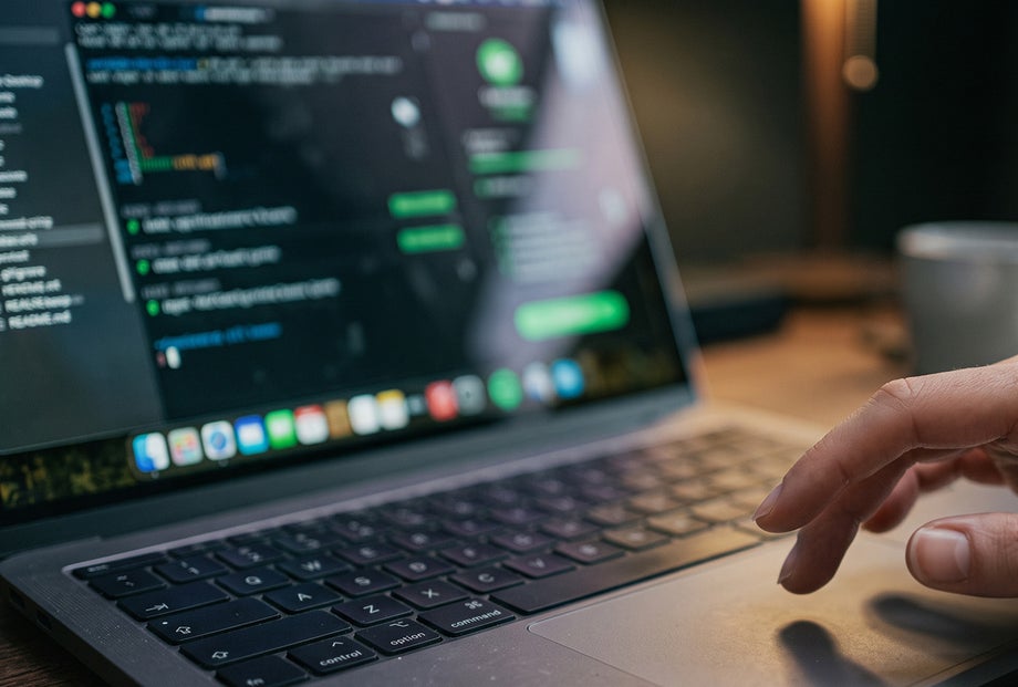 Person using a laptop for QA testing