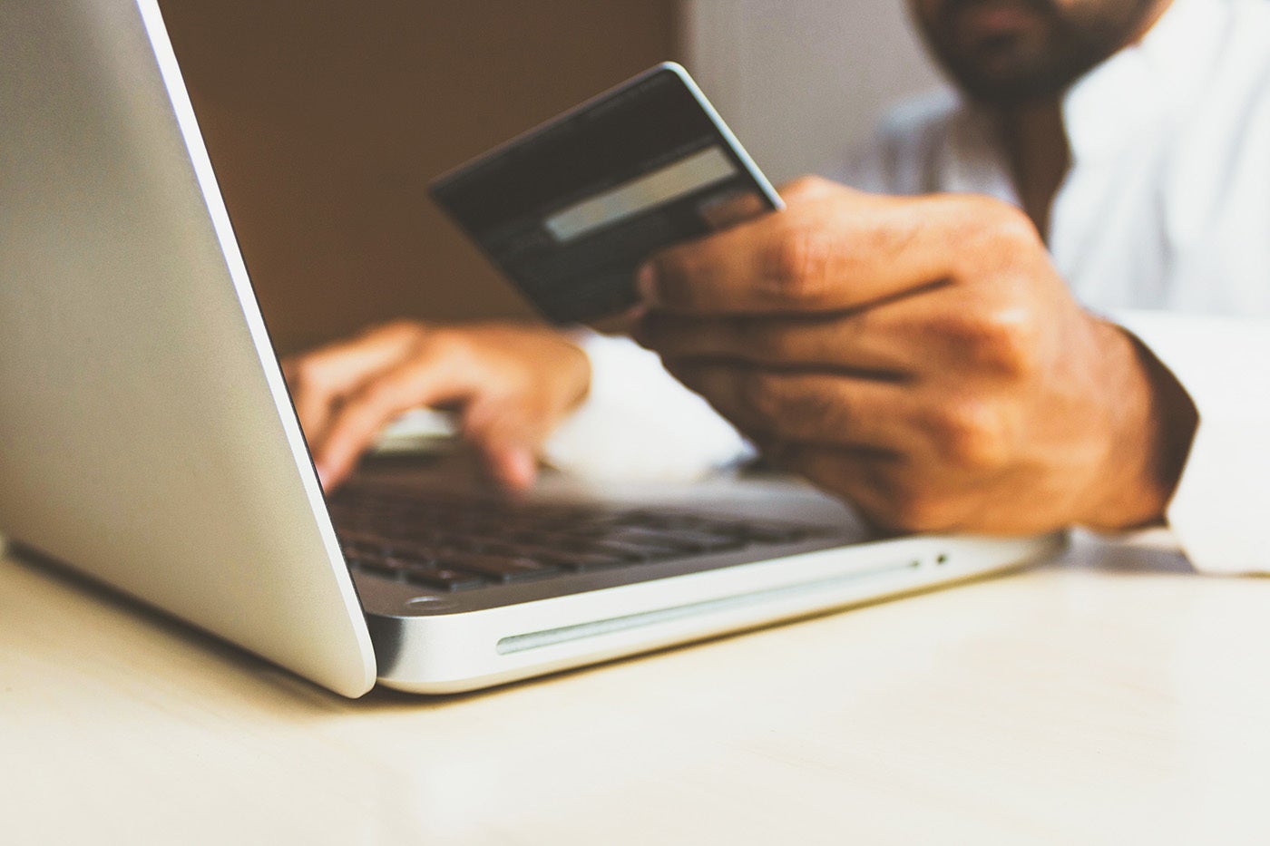 A man finalising a purchase on his laptop