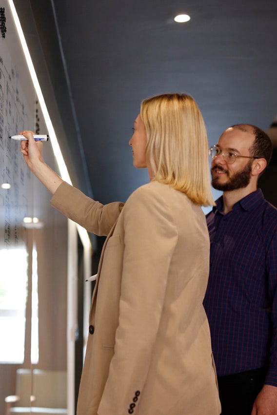 All Human team collaborating at a whiteboard