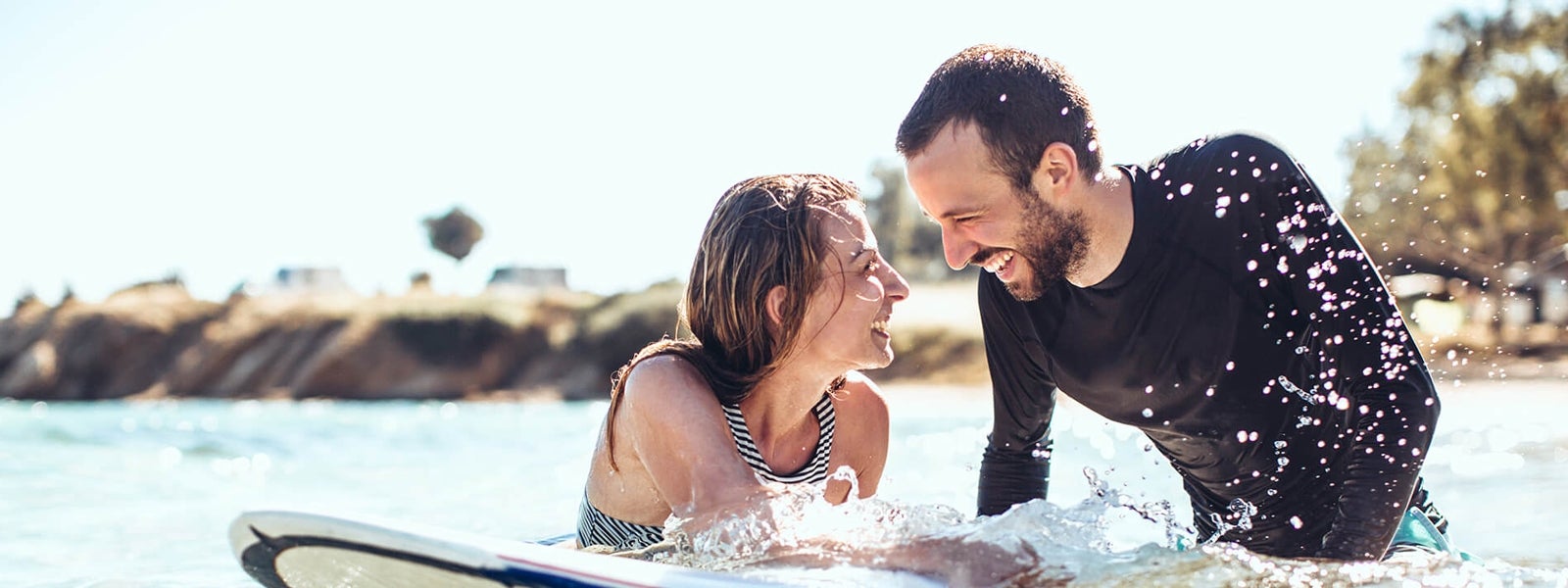 Two people surfing look at each other