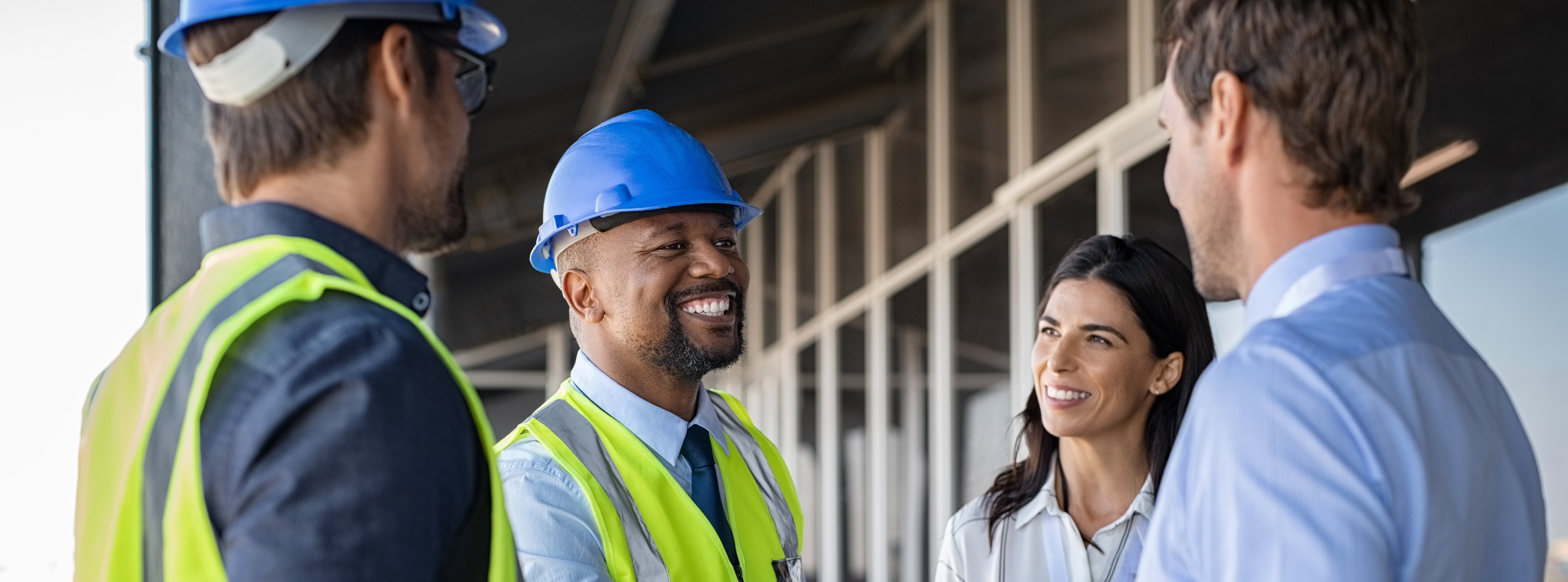 Workers in hard hats shake hands