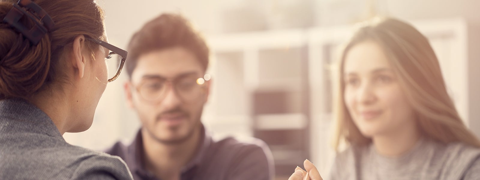 Two employees meet with advisor