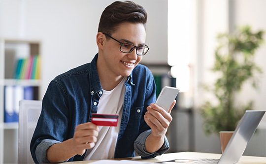 Man looking at checking account. 