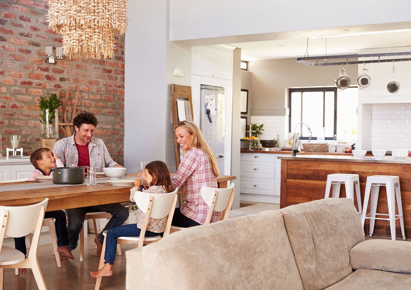 Family of four sits at dinner table
