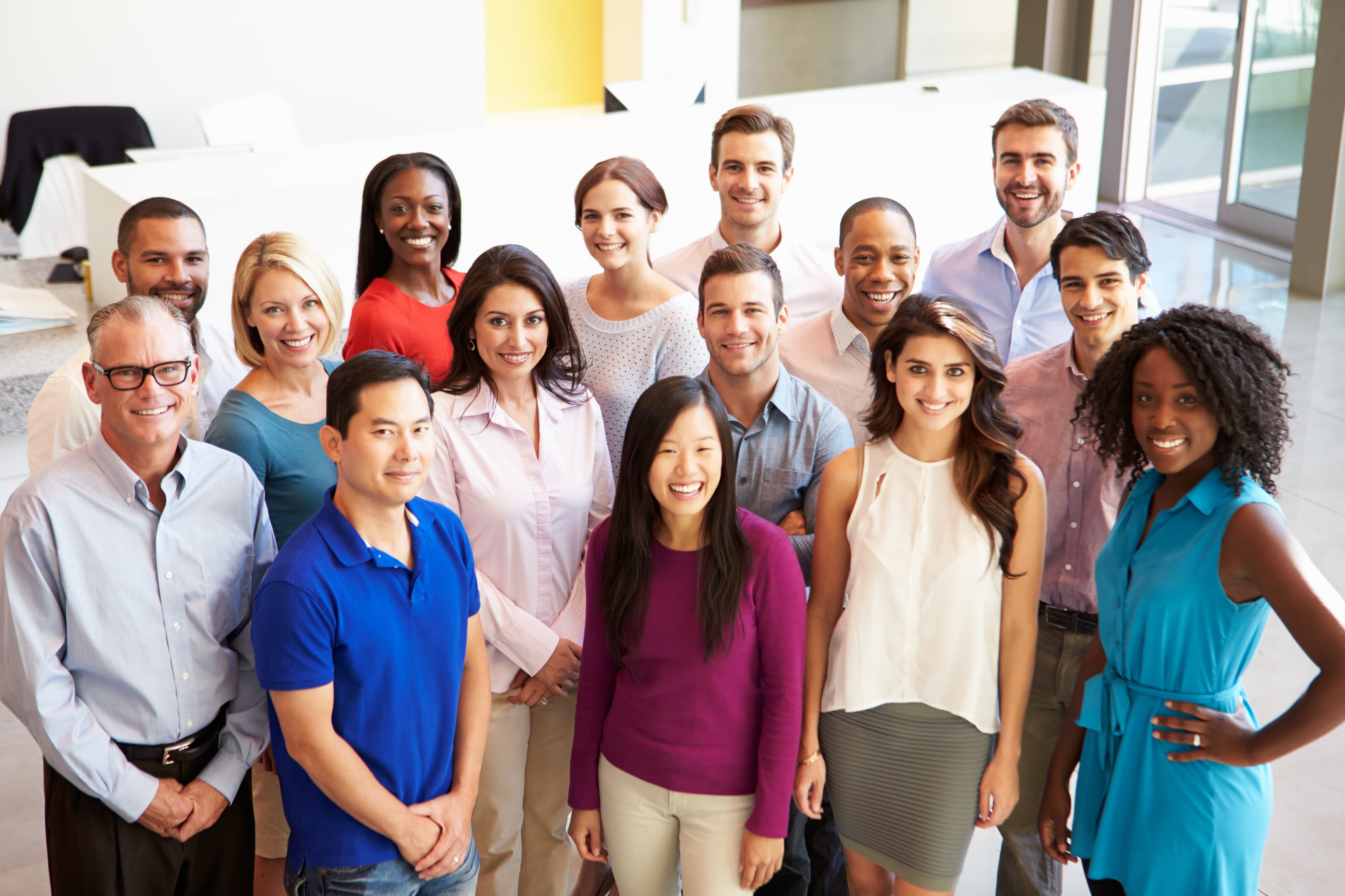 Employees smile together in a group photo