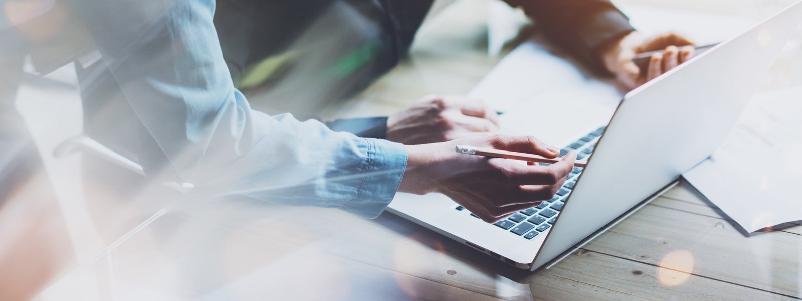 two people look at something on a computer screen