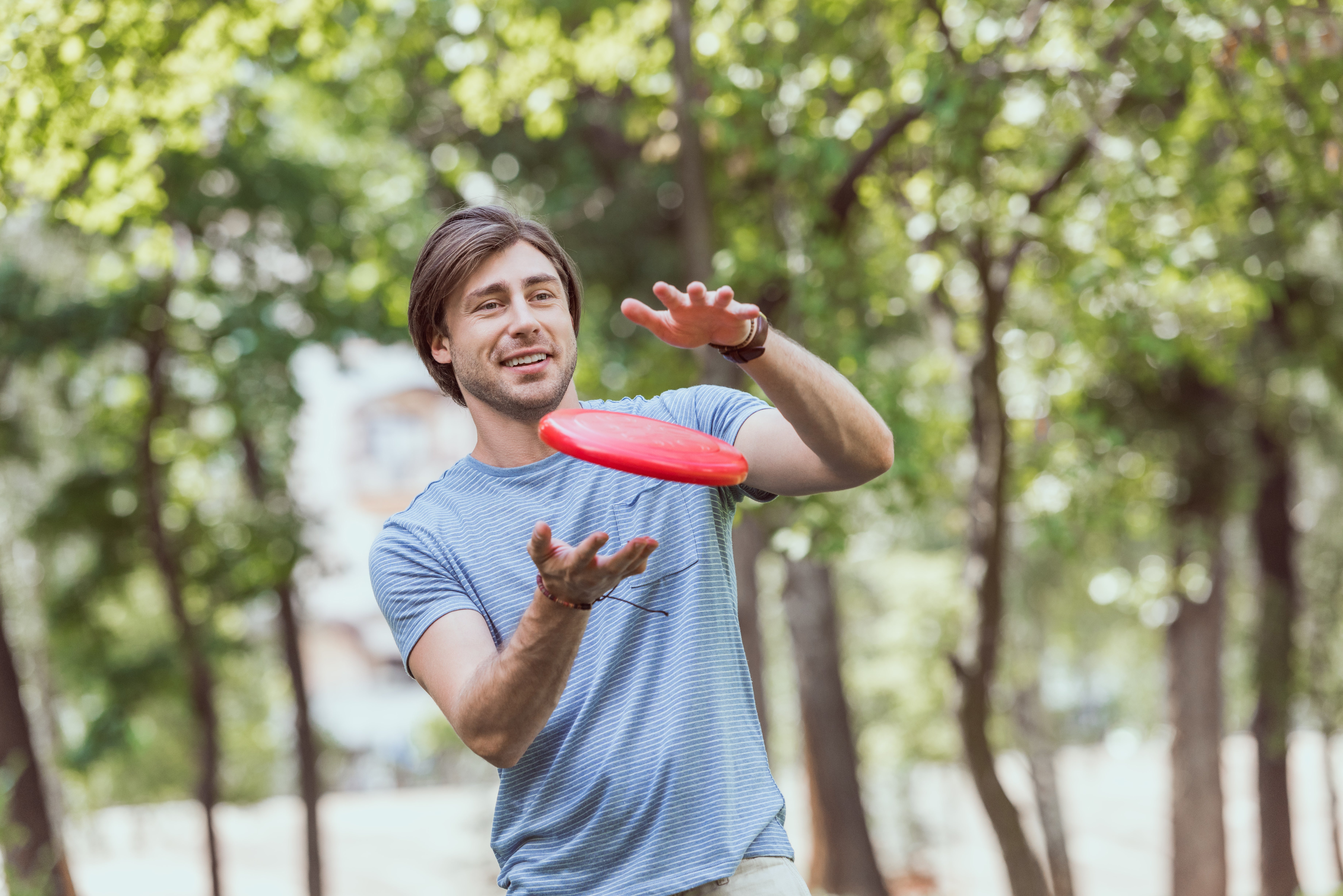 Man catches a frisbee with two hands