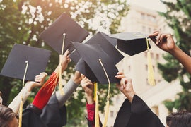 Graduations caps held up in the air