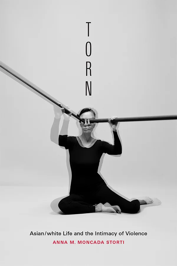 Cover of Torn is black and white and features a double exposed photograph of a person holding two thin long tubes up to each eye.