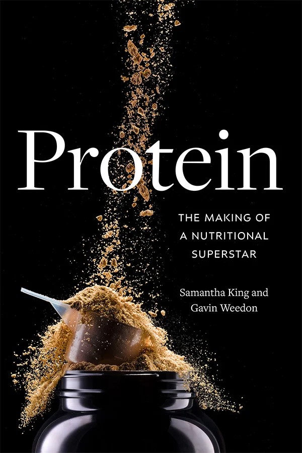 Cover of Protein is black featuring a jar at the bottom with a golden brown powder exploding from it. The powder extends from the top of the cover down to the jar. There is a measuring scoop filled with powder that rests on the bottle&rsquo;s opening