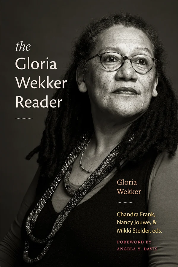 Cover of The Gloria Wekker Reader has a sepia photograph of Gloria Wekker. The title appears to the left of Wekker's face in a cream sans-serif font. A dotted line is under the title.