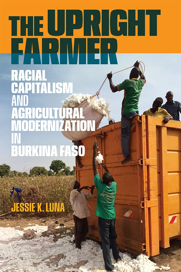 Cover of The Upright Farmer shows a photograph of individuals loading cotton onto an orange truck in a rural field covered in cotton.