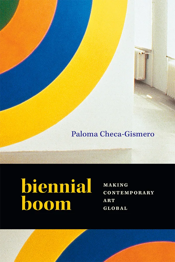 Cover of Biennial Boom features a photograph of a light-filled room. On the wall is a quartered section of a large semicircle, with yellow, blue, orange, and green stripes.