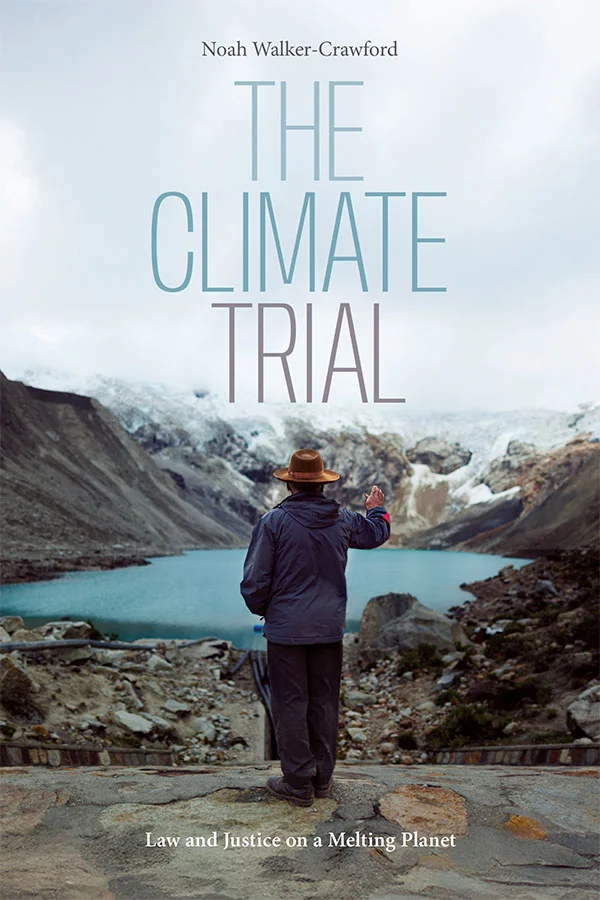 Cover of The Climate Trial features a photograph of a person looking out at icy mountains and a bright icy blue lake. The individual wears dark pants, a navy blue jacket, and a tan hat.