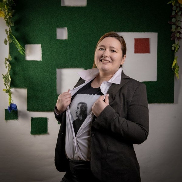 An actor reveals a t-shirt with Vaclav Havel under their suit.