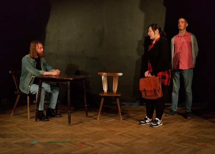 The Marshal speaking with Dr. Galén while his Aide stands ready to arrest her.