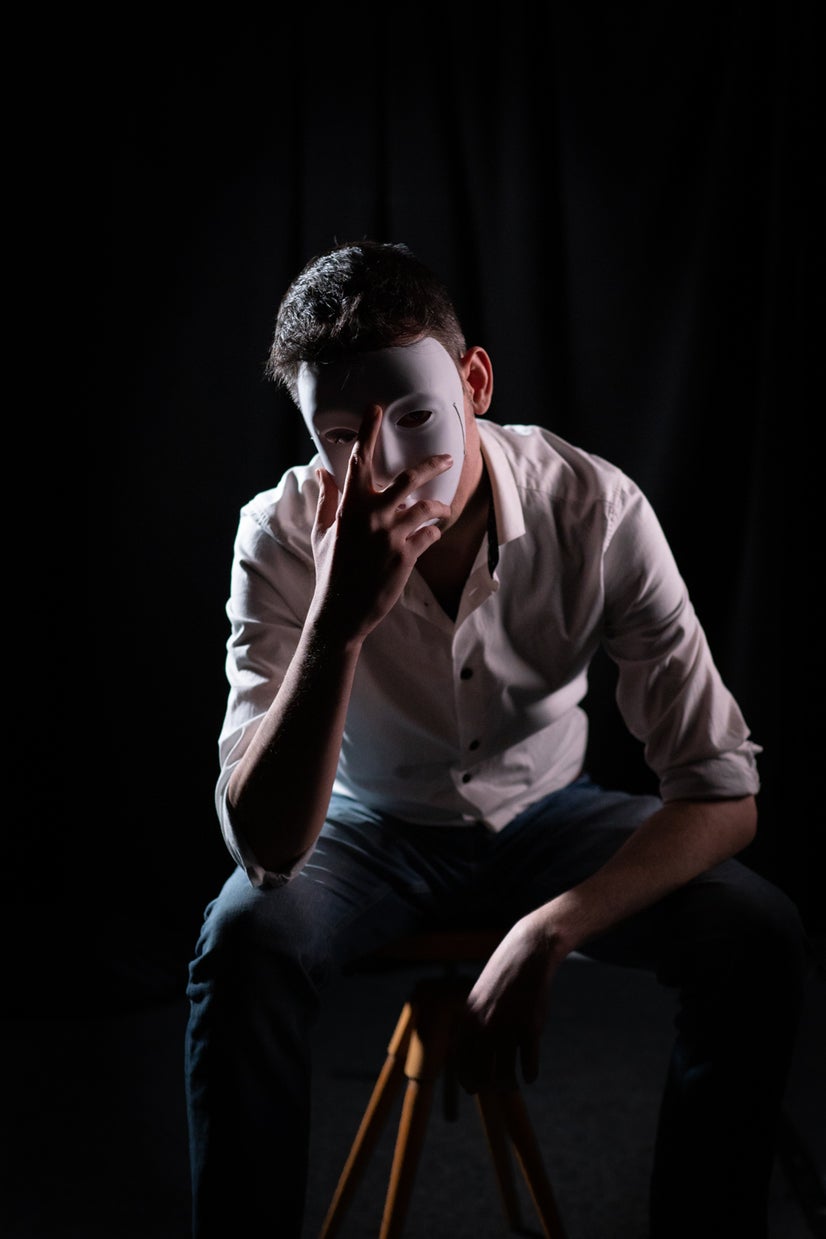 A photo of Salih behind a mask.