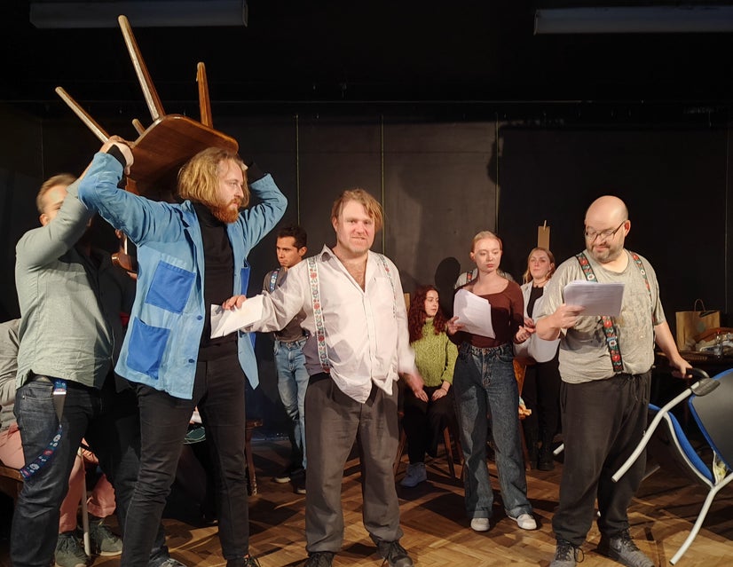 Bláha is held back from attacking with a chair while Dubský stands in the middle of it all.