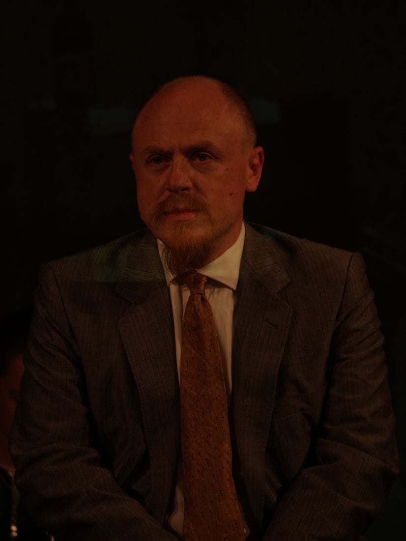 A man in a suit looking sad.