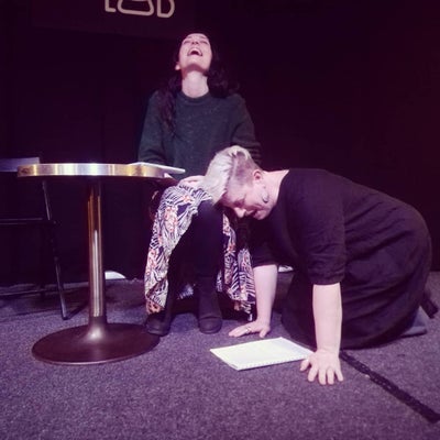 Enjoying a laugh while rehearsing a tragedy.