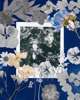 A black-and-white picture of a woman behind flowers.
