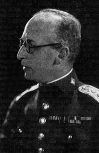 A man with glasses in a military uniform with medals.