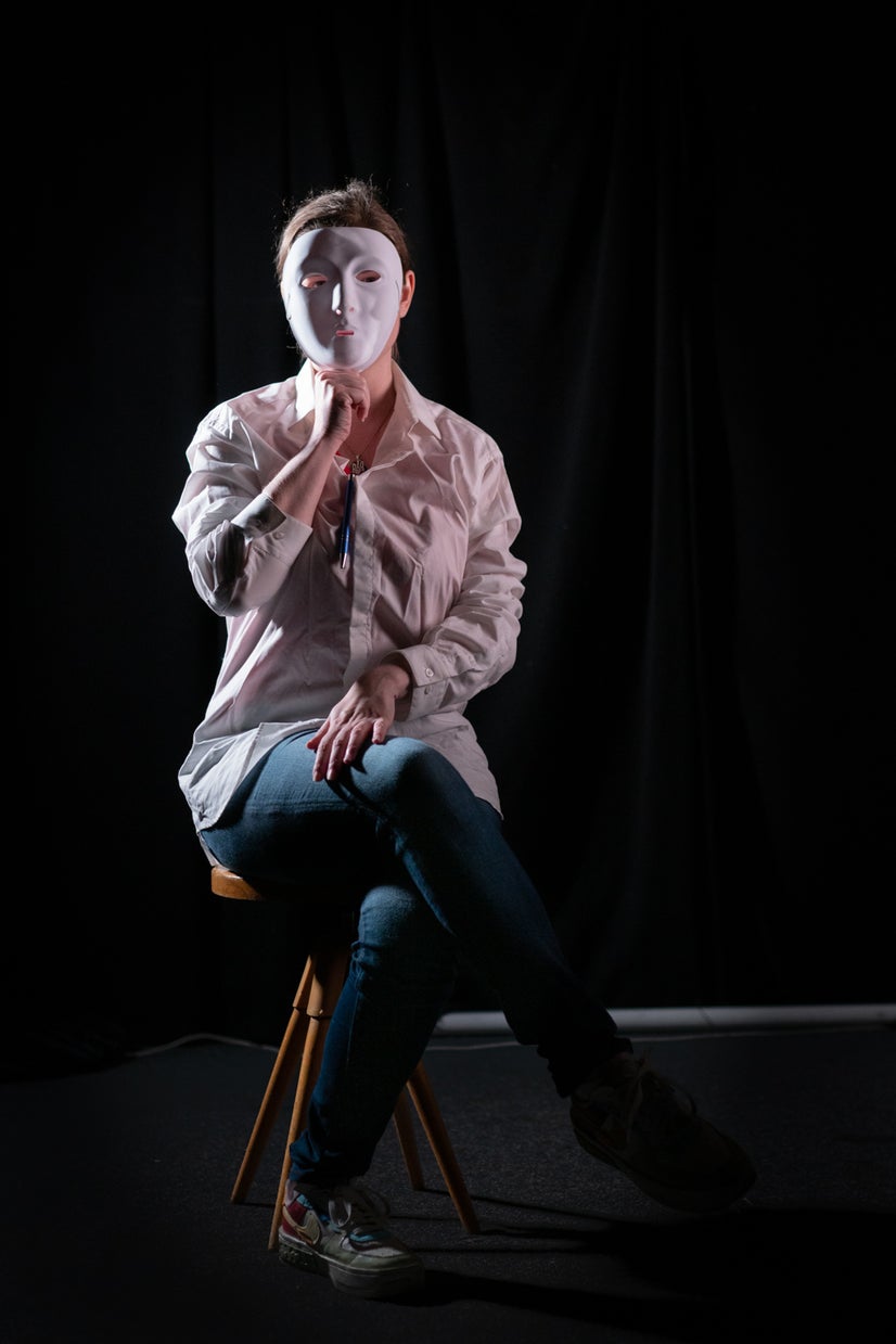 A photo of Lisa behind a mask.