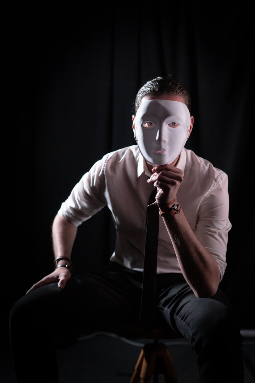 A photo of Andres behind a mask.