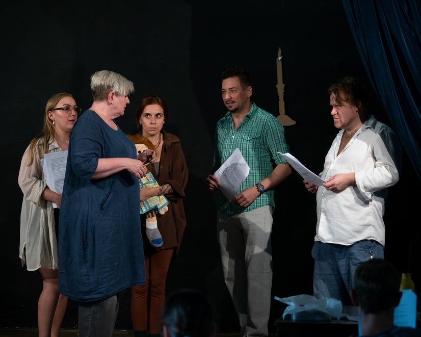 The director gives instructions while the actors listen carefully.