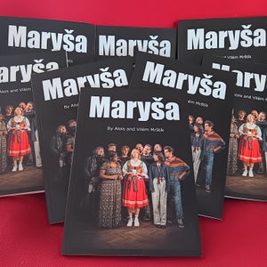 A bunch of printed copies of Maryša on a red background.