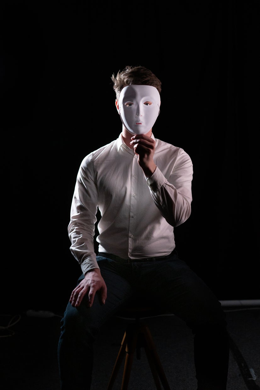 A photo of Kein behind a mask.