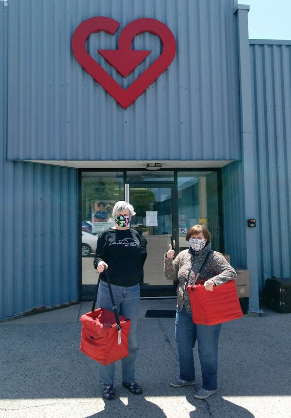 2.	VAC Sycamore Illinois site with Meals on Wheels Volunteers carrying meal bags.