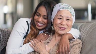 Millenial caregiver with older Asian woman