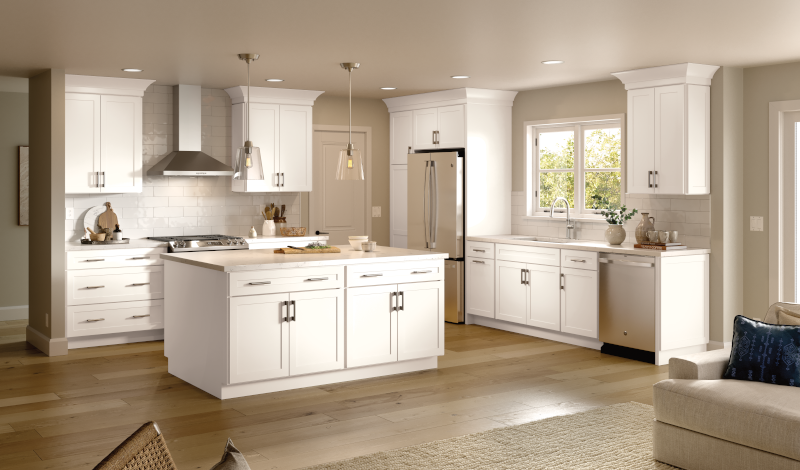 A kitchen with wood floors and white cabinets.