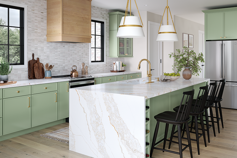 A modern kitchen with green painted wood cabinets and a white marble island.
