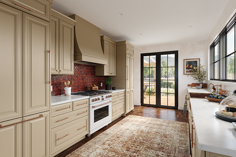 An enclosed kitchen with a glass door and windows as well as beige kitchen cabinets and white countertops.