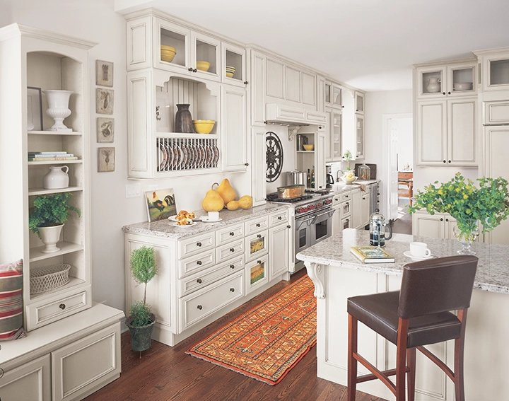 A white-on-white kitchen with country decor.