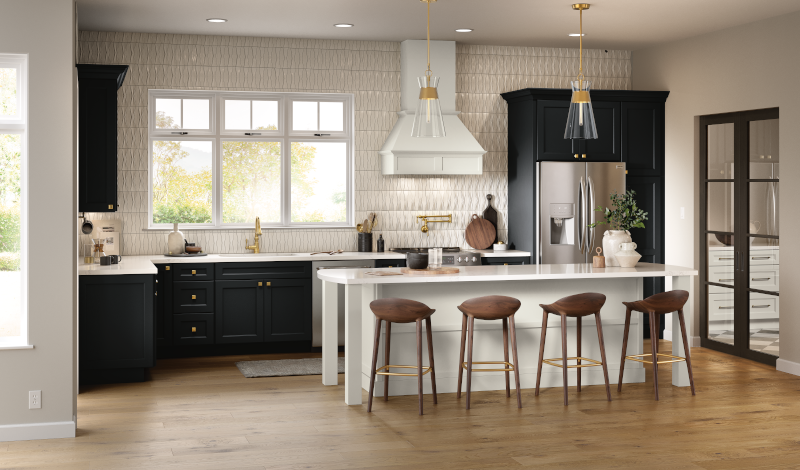 A kitchen with black cabinets, a white island, and white countertops.
