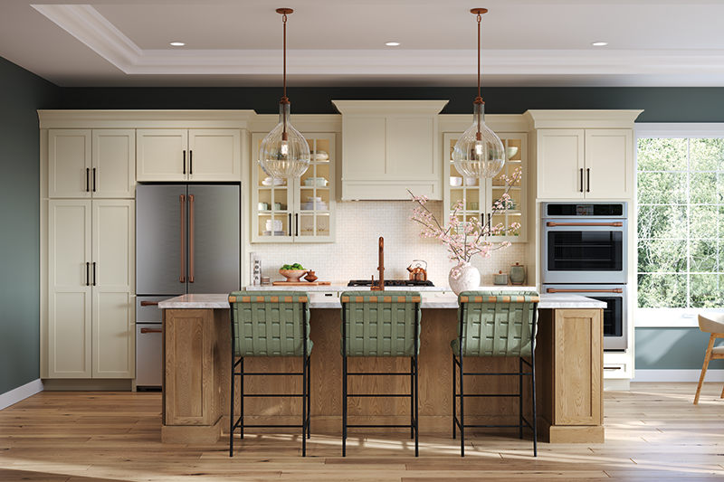 A kitchen with natural lighting coming in from the right, with a center island in natural wood, green barstool chairs, and off-white cabinets.
