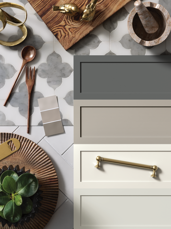 A flat lay containing kitchen cabinet doors, hardware, utensils, and other kitchen items.