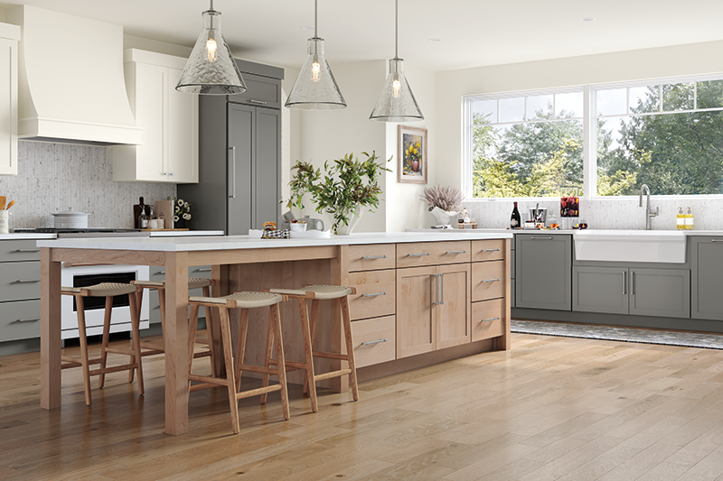 A kitchen with gray kitchen cabinets, a wood-toned island, and windows.
