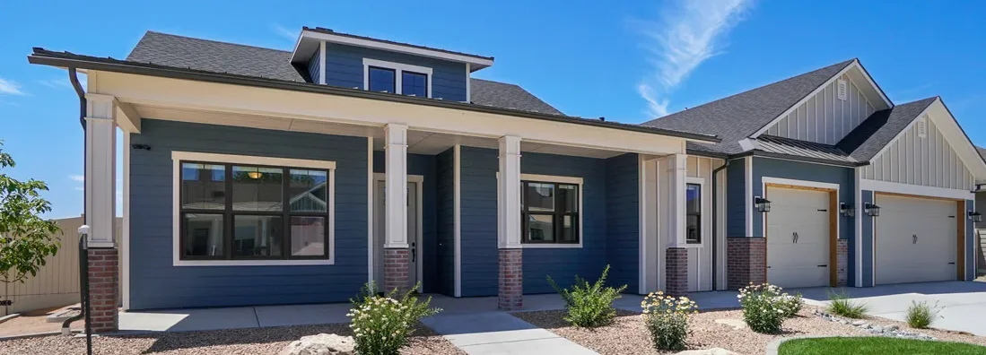 Modern blue and white home with landscaping. Leawood, Kansas Homeowners Insurance.