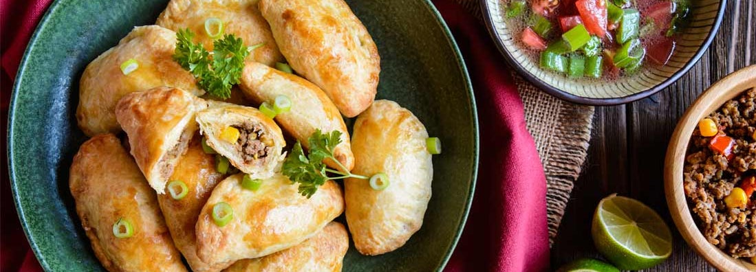 Empanadas stuffed with minced beef, pepper and corn, served with Aji Picante sauce