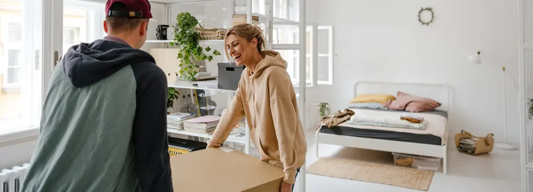 Young couple moving into a new apartment. Find Rhode Island renters insurance.