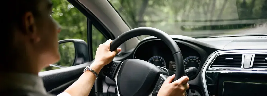 Close up of man driving car in Arkansas. Find Bentonville, Arkansas car insurance.